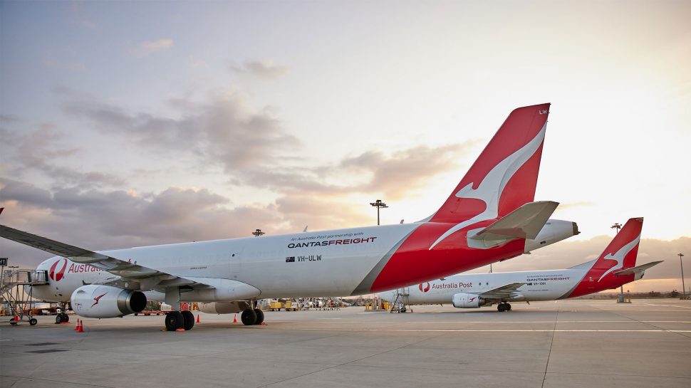 Two Australia Post-Qantas airplanes parked on the tarmac.