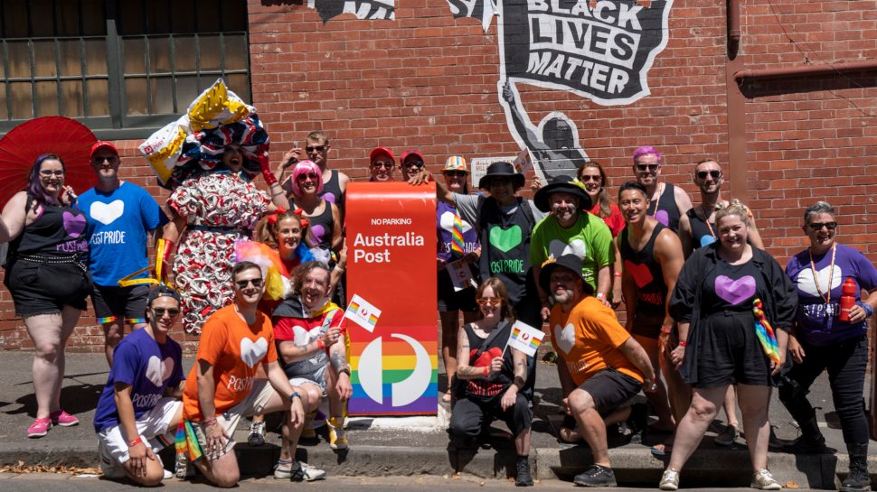 Vin Tagè and Australia Post team members pose for a photo during the Midsumma Pride march. 
