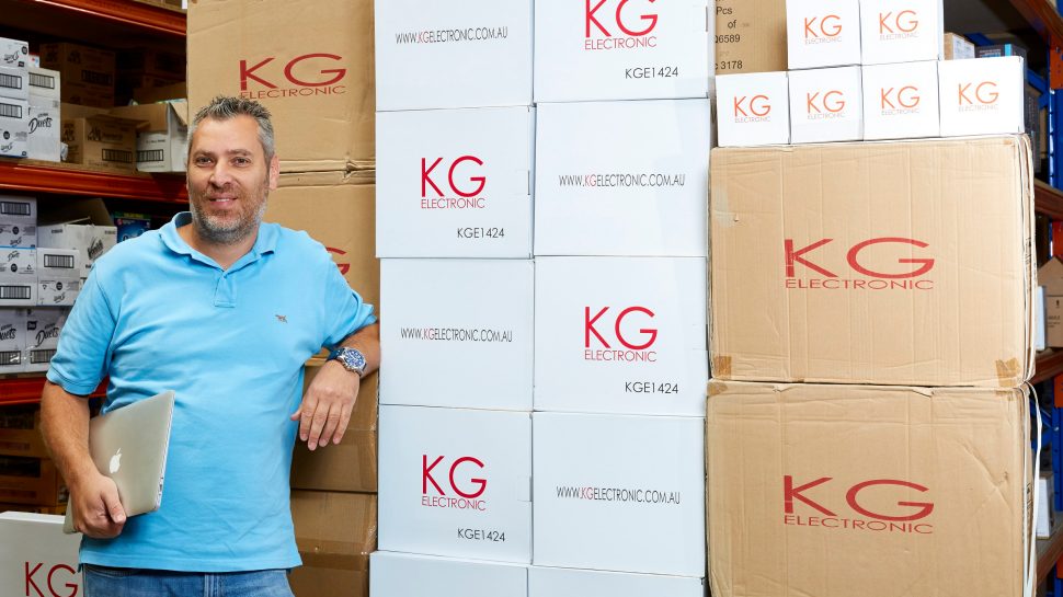 Doron Kushlin standing in front of boxes in the warehouse of KG Electronics